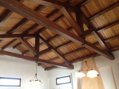Vista interna della ristrutturazione del tetto di magazzino con capriate, arcarecci e perline in legno Larice Siberiano, realizzata a Trapani (TP)